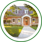 An exterior walkway leading to the front door of a large home.